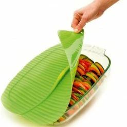 Charles Viancin Silicone Banana Leaf Baking Lid - Square, 10" X 10" -Stovetop Tea Kettles Shop charles viancin banana leaf baking cover action shot compressed